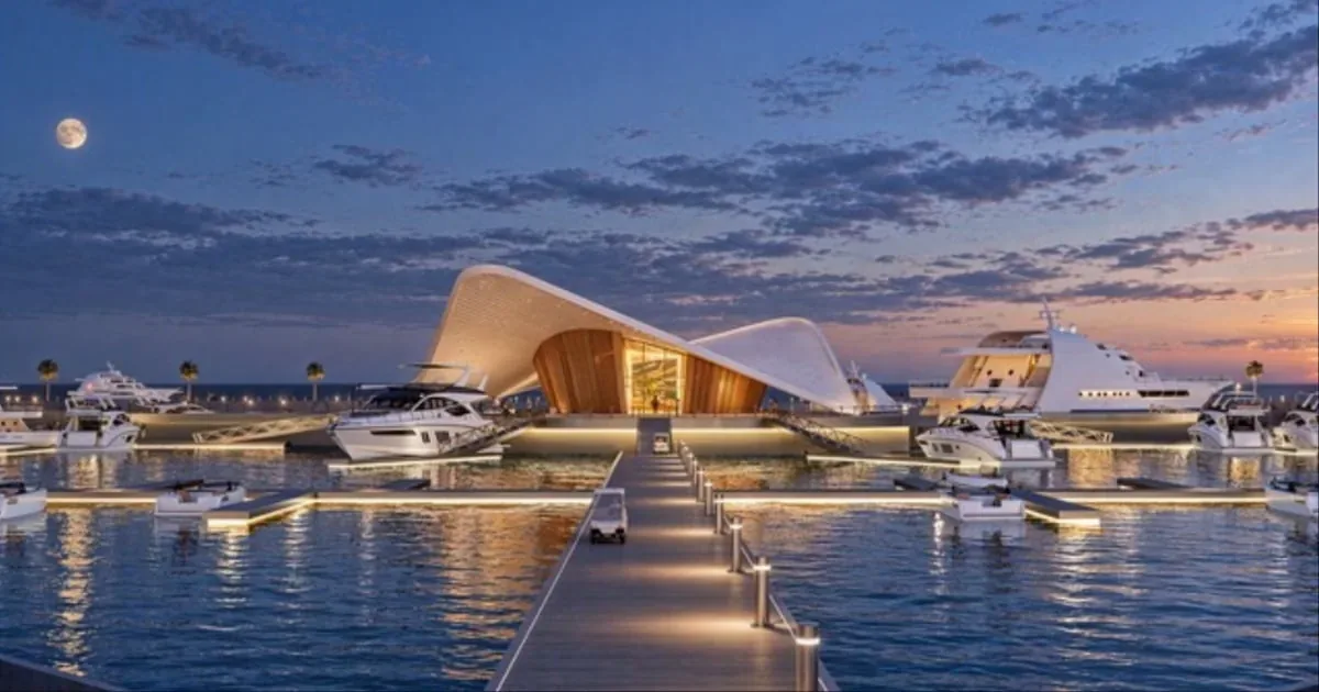 Evening rendering of the illuminated Wynn Marina walkway and Capitainerie surrounded by yachts